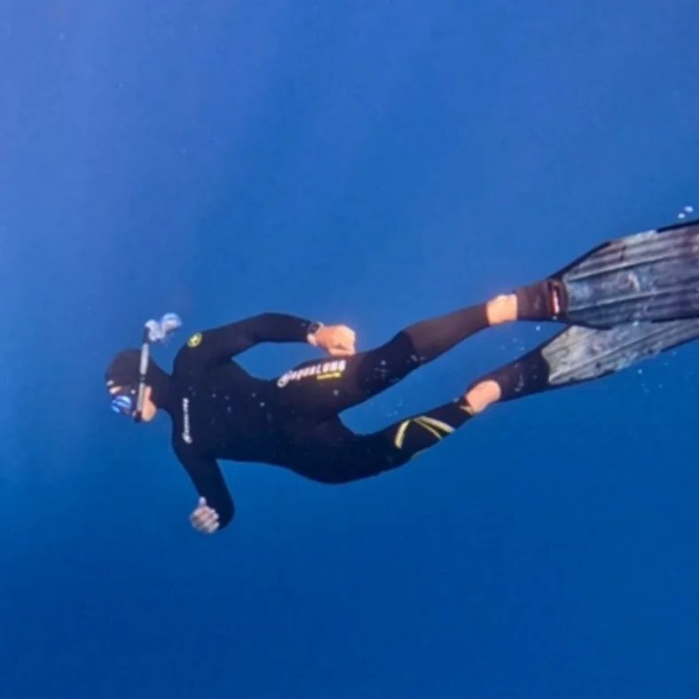 Cristiano freediving in deep blue water
